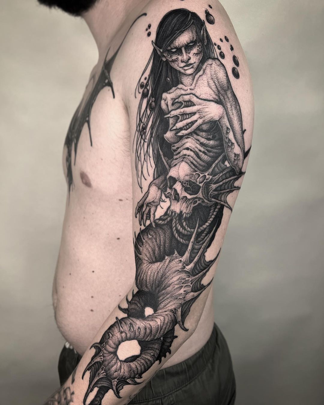 Black Ink Mermaid Tattoo On Women Left Half Sleeve By Gene Coffey